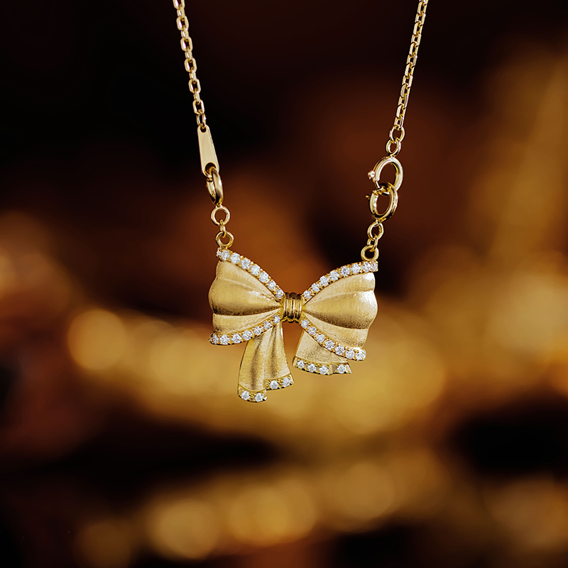 12763 Large bow diamond-encrusted trend pendant.